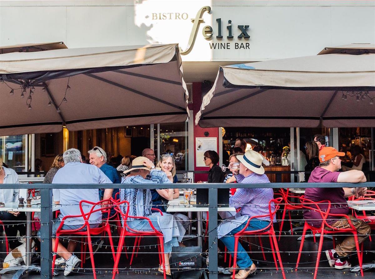 people sitting at tables outside of Bistro Felix Wine Bar