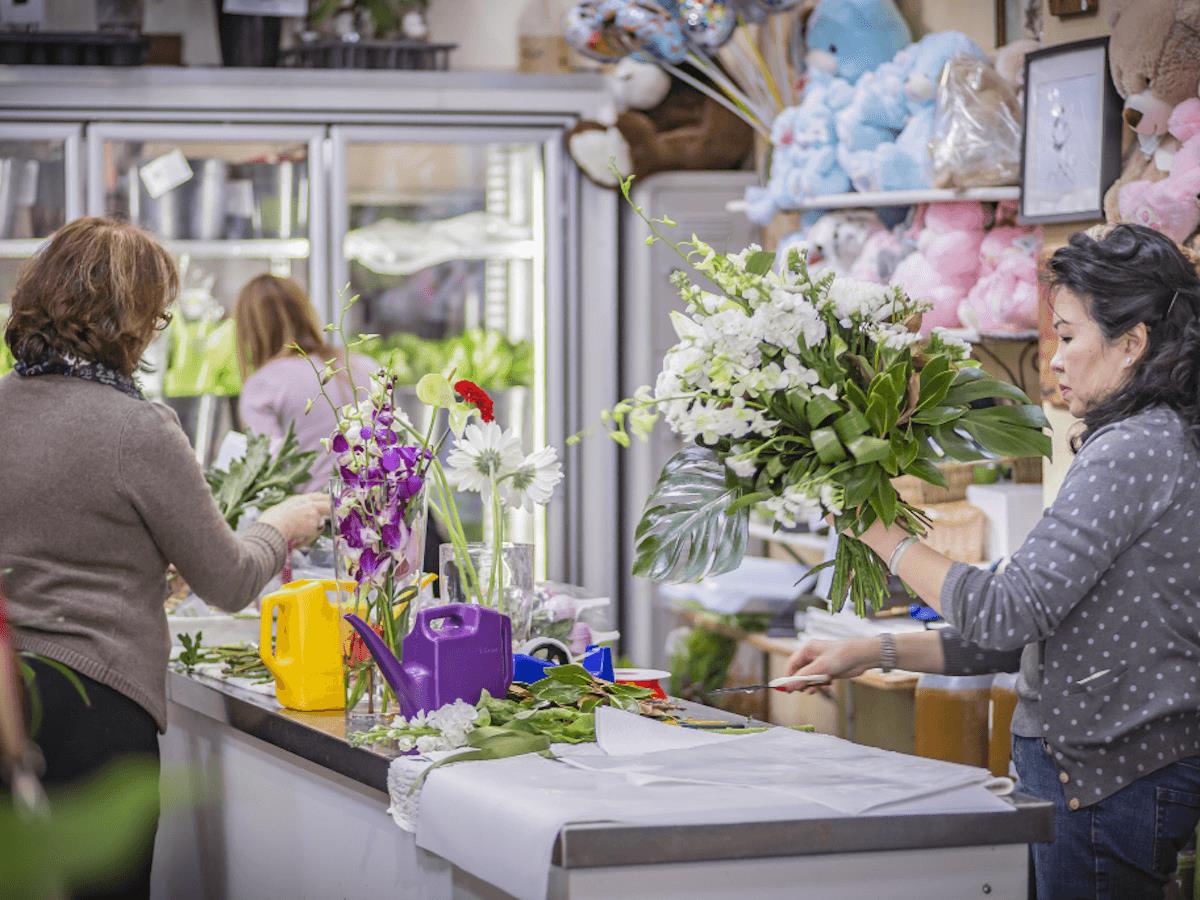 Owners at the Cottage Garden packing flowers at the front desk